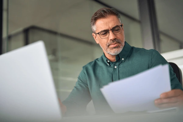 Executive reviewing documents at a desk